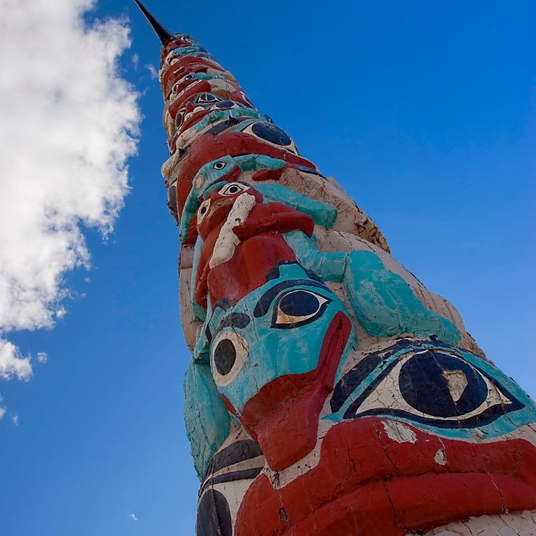 seen from a low angle view of a white, orange and light blue totem